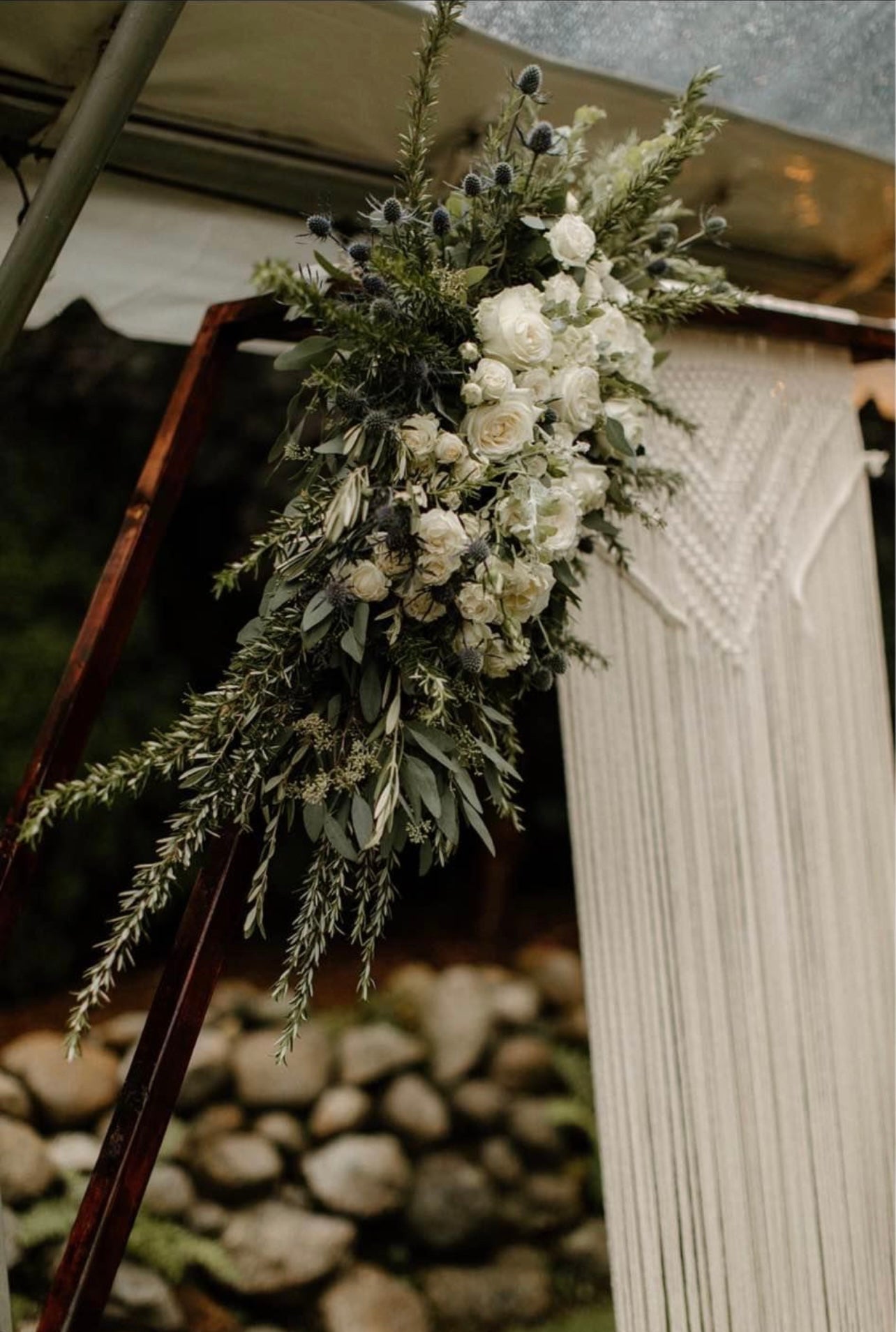 Elegant wooden hexagon arch setup for an outdoor wedding ceremony.