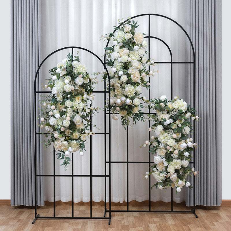 Black round top grid arch used as a floral backdrop for an event