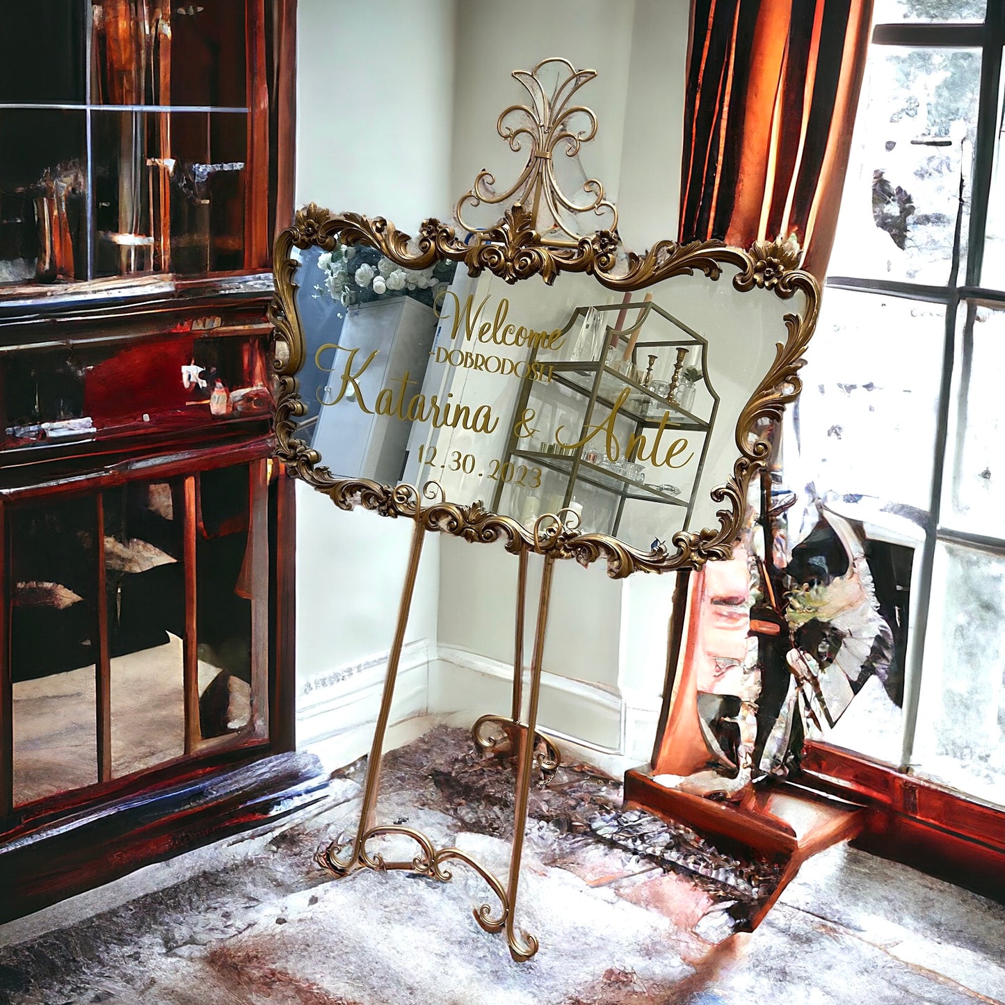 Vintage gold mirror displayed on a stand in an event setting.