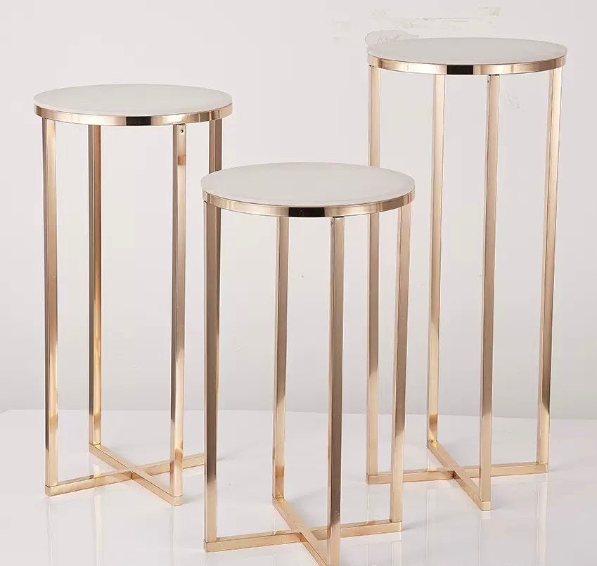 Gold geo dessert stands for elegant event displays.