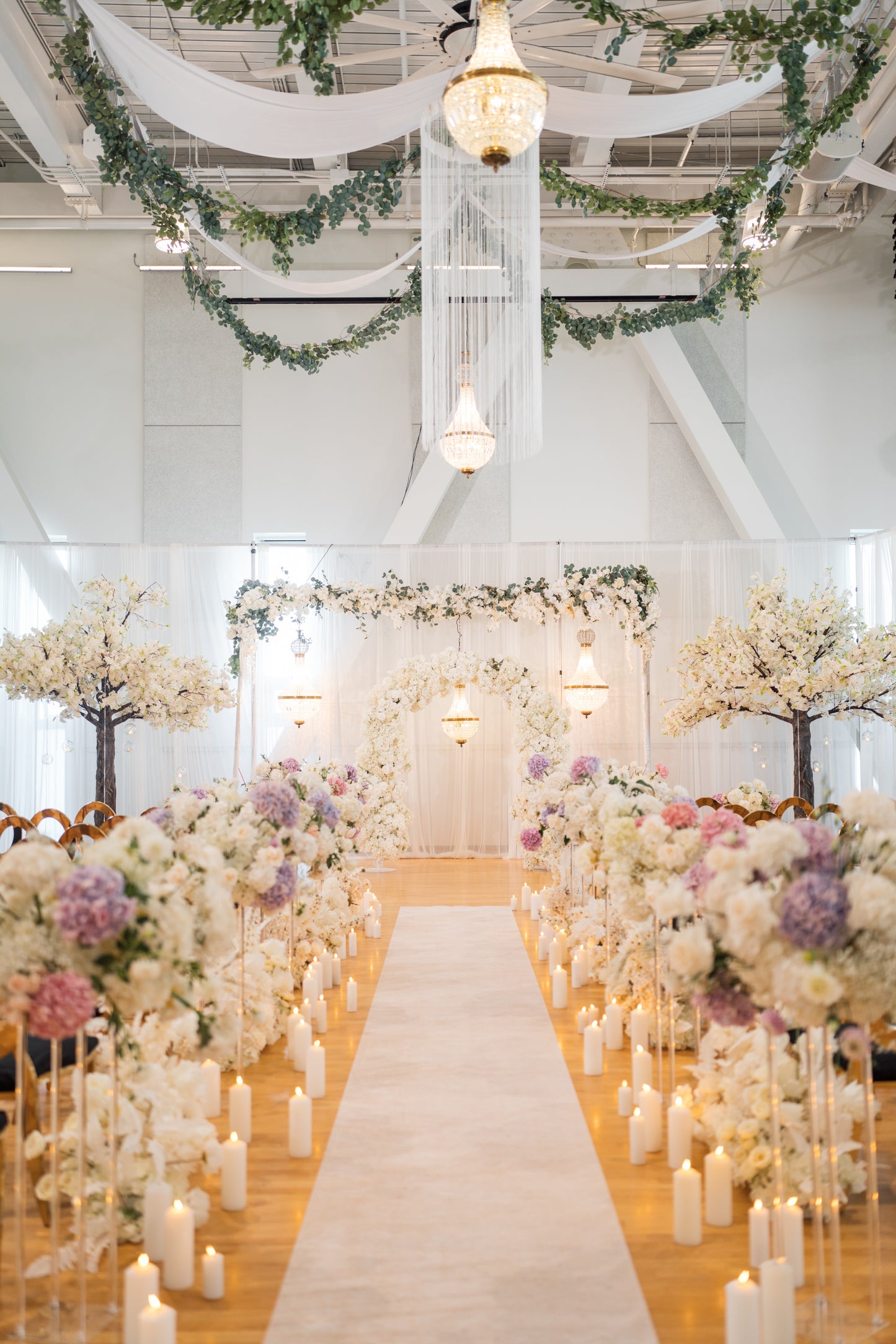 Elegant white round string hanging fringe used as ceiling decor for an event.