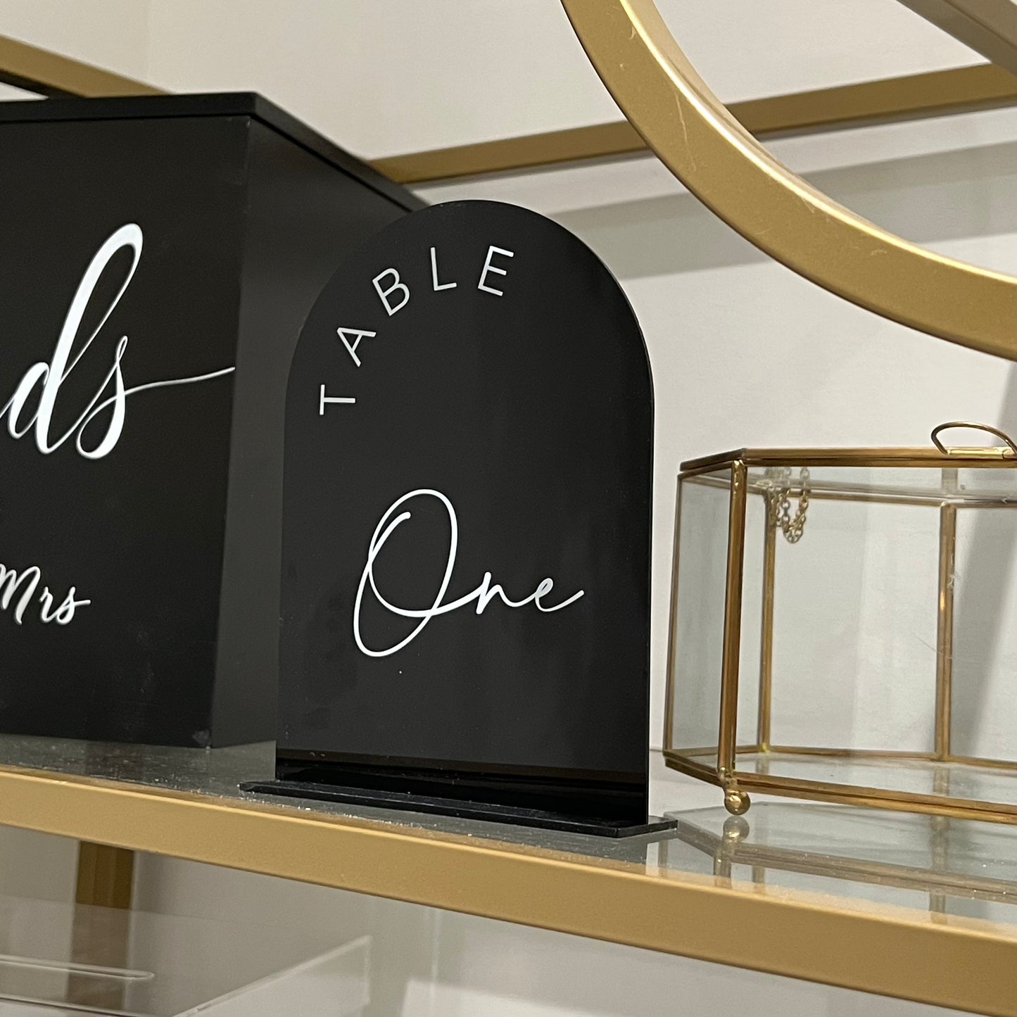 Black acrylic table numbers with white font and holder for event decor. Set of modern black acrylic table numbers for weddings and parties.