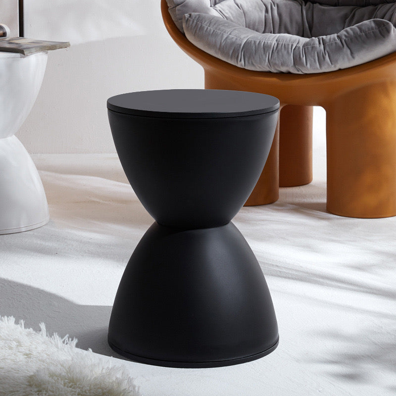 Black Nordic side table/stool in a modern living room setting.