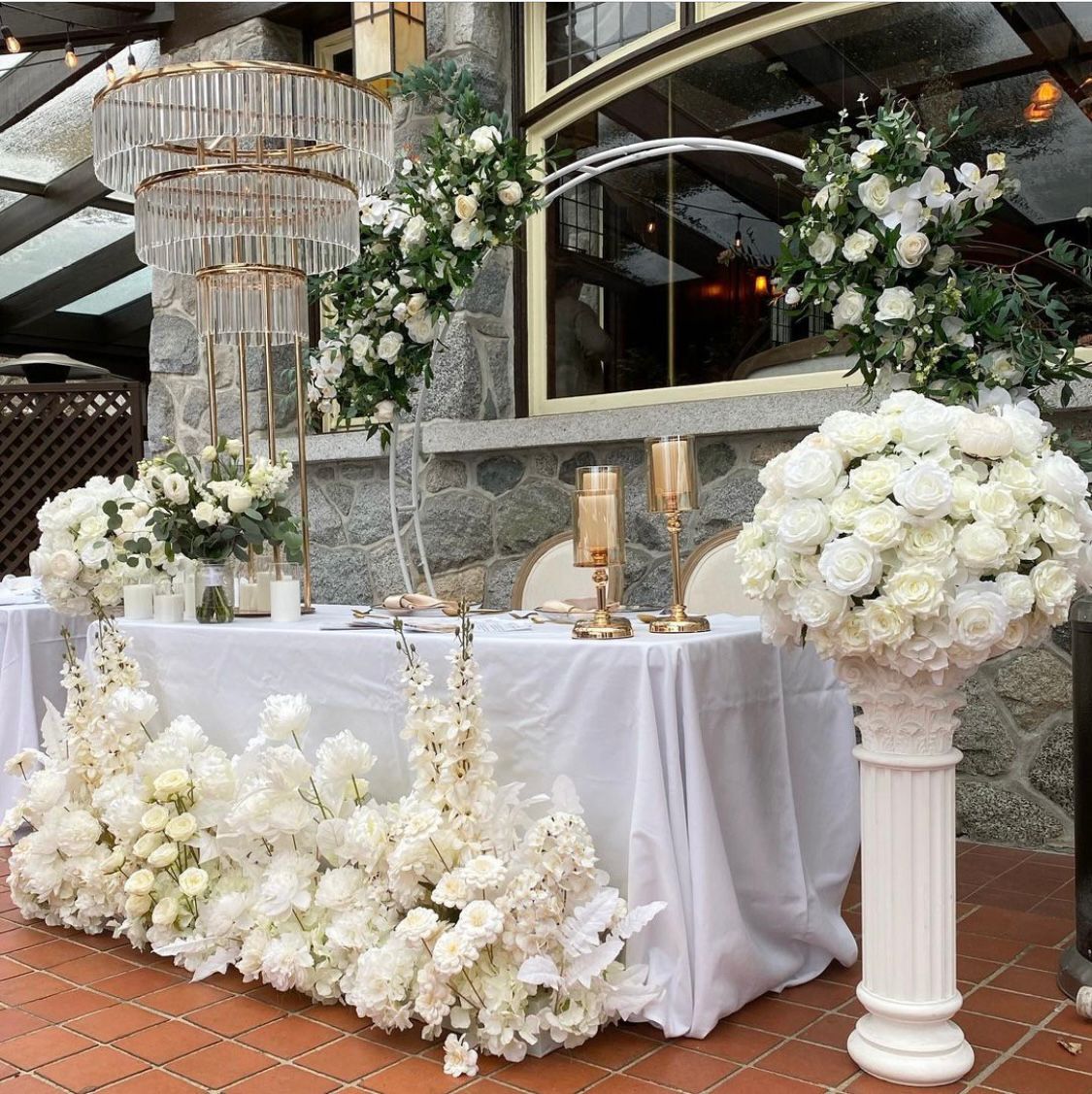 White Circular Arch setup at a wedding reception with elegant floral arrangements.
