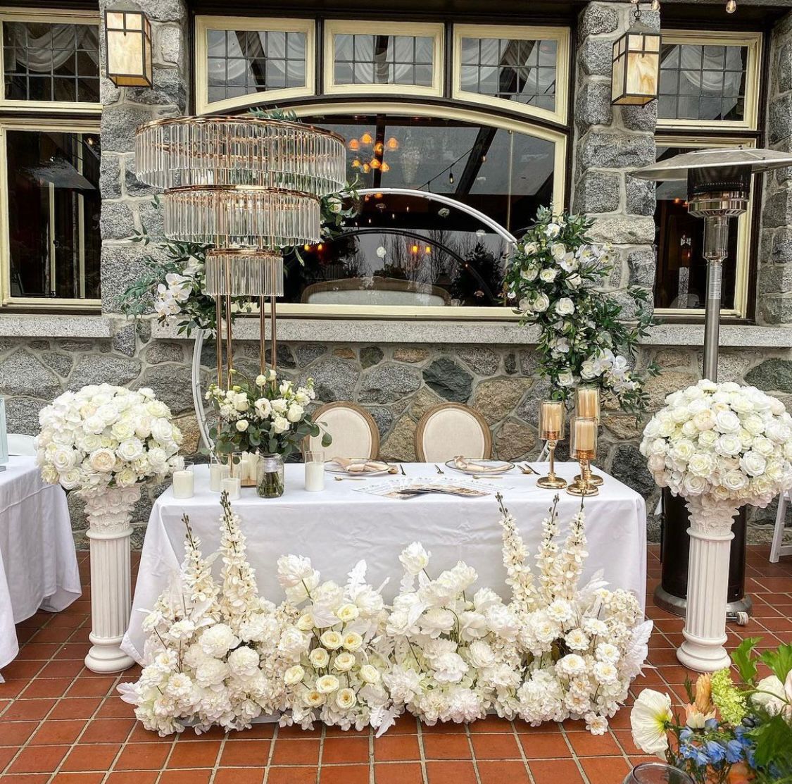 Double Layer White Circular Arch decorated with flowers, used at an outdoor wedding event.