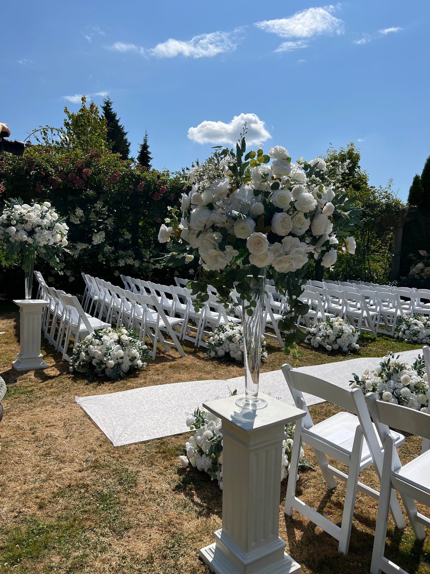 Versatile white pedestal stand for decorative items at a wedding