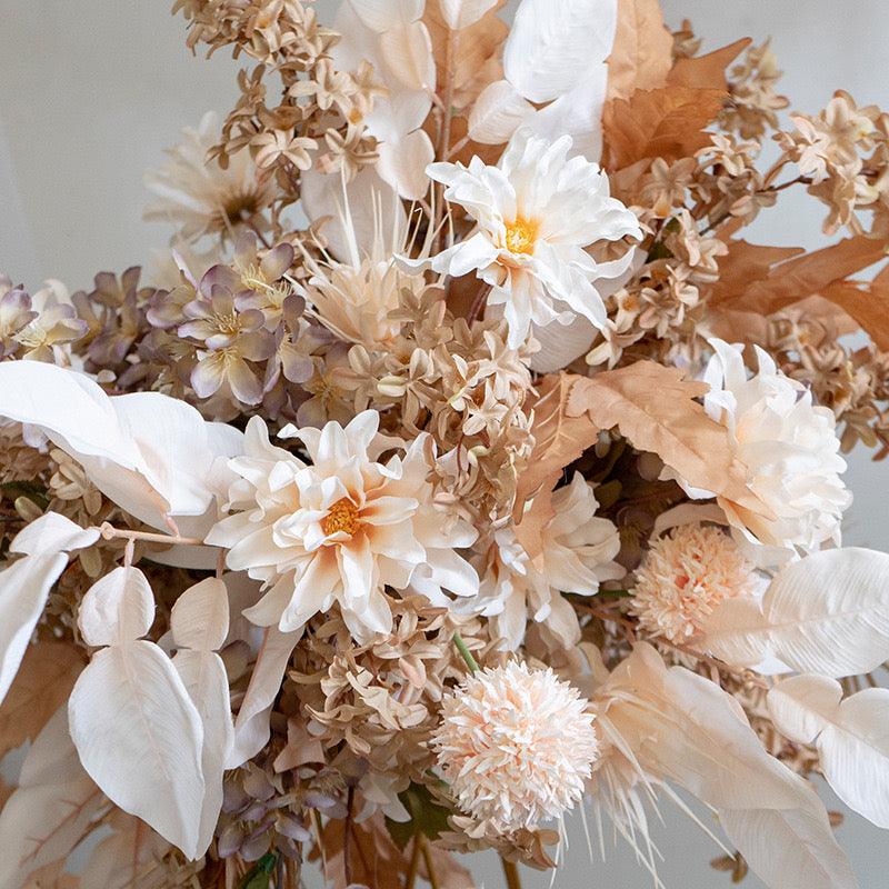 Close-up of terracotta theme silk floral arrangement.