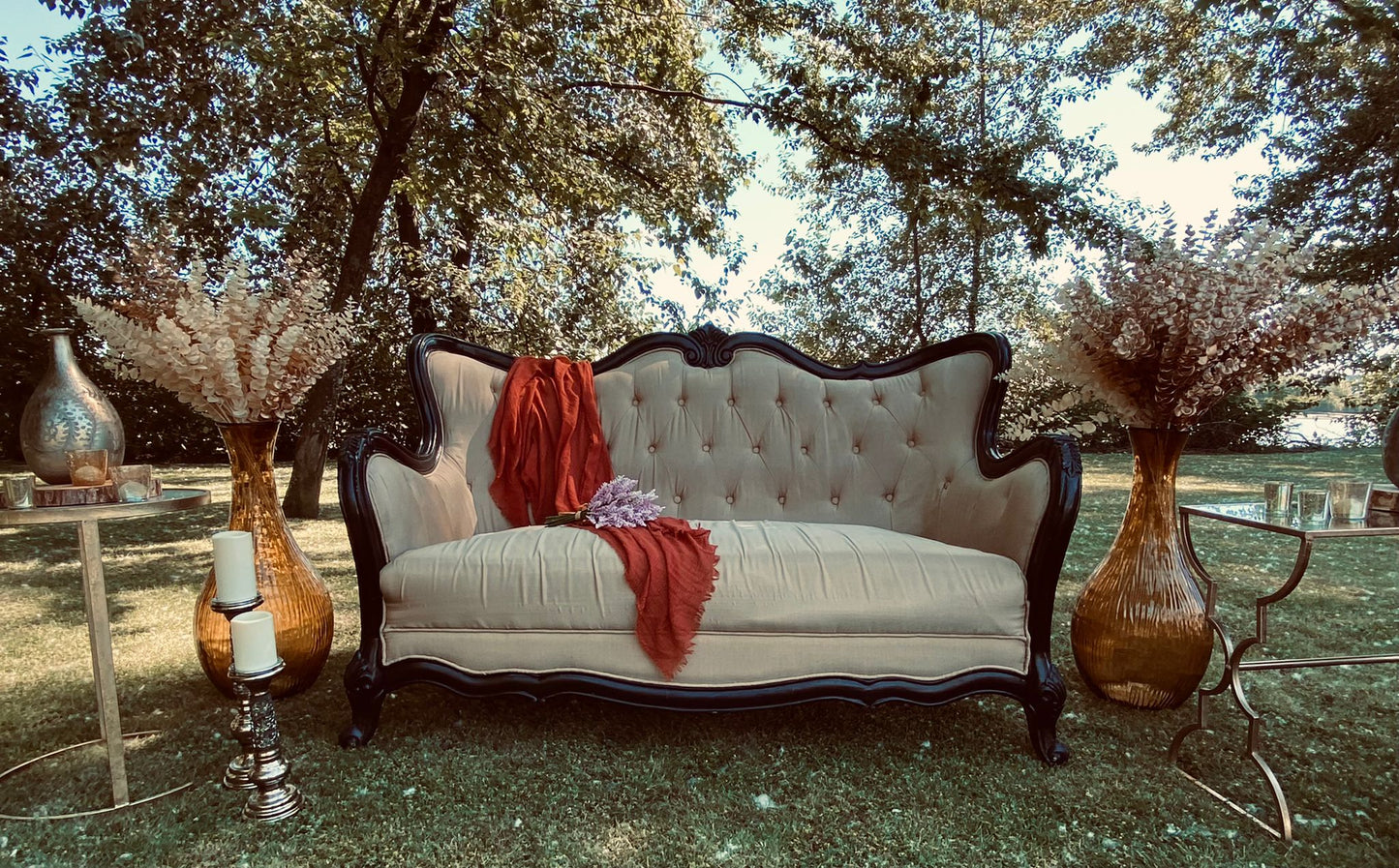 XL round garden vase filled with pampas grass next to an elegant outdoor seating arrangement.