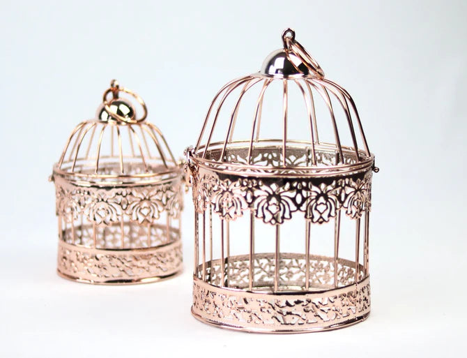 Elegant gold bird cages used as decorative centerpieces.