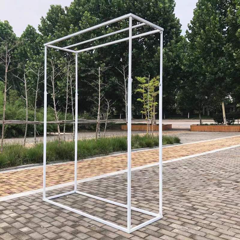 White metal rectangle frame arch set up in an outdoor venue