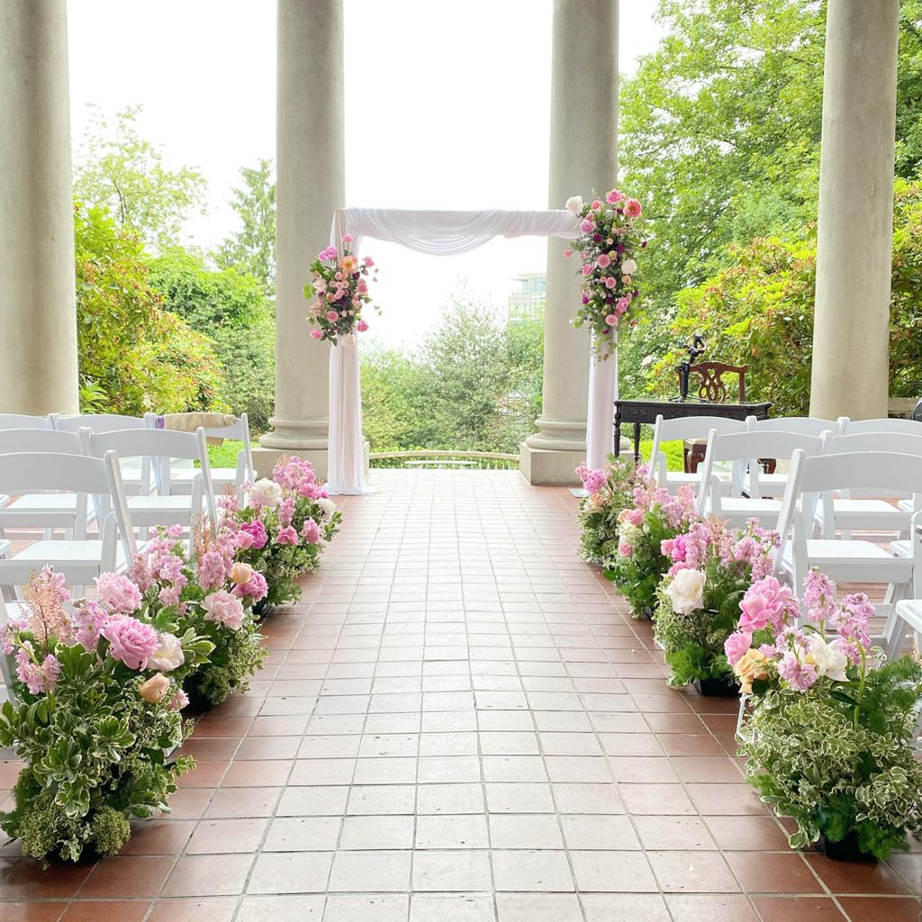 Elegant wooden arch setup as a backdrop for an outdoor wedding event.