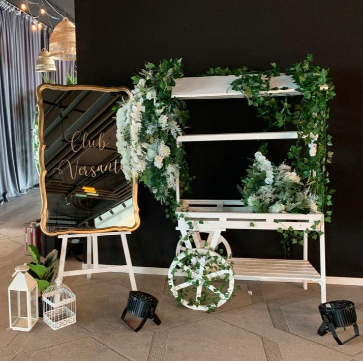 Large rectangle gold antique mirror used as a welcome sign with floral decorations