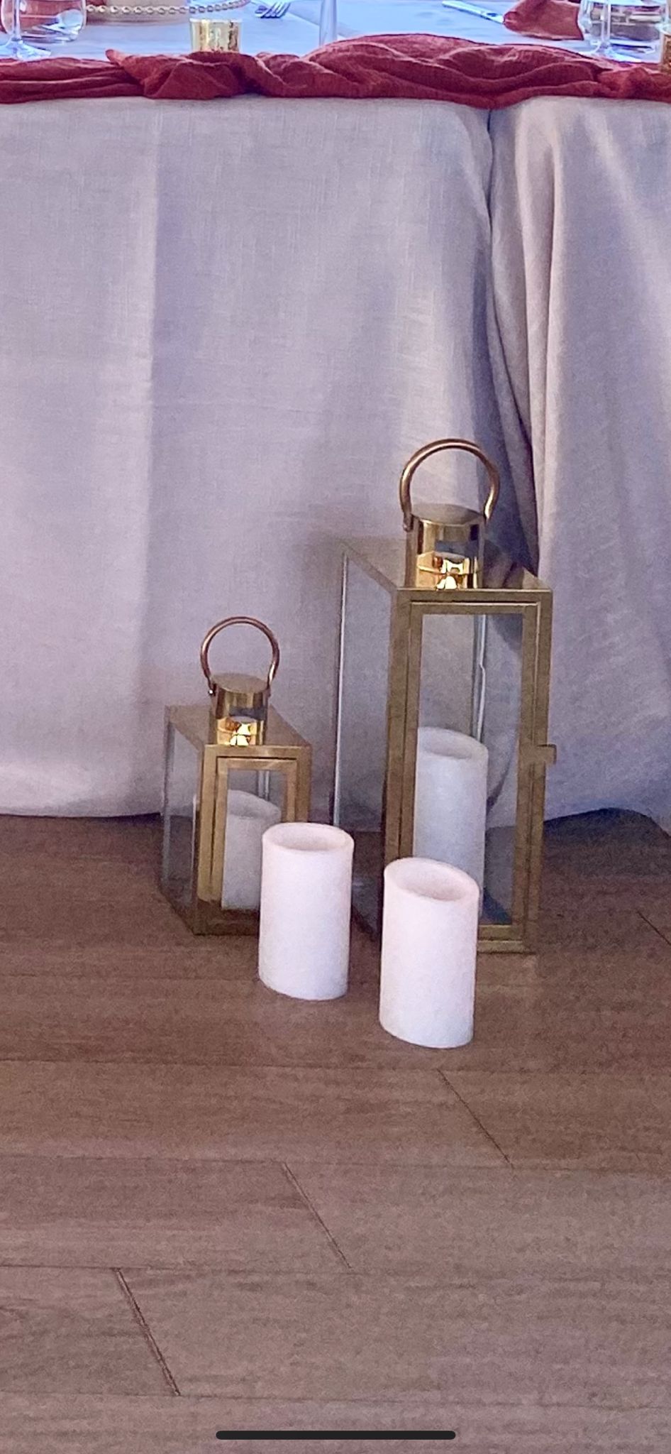 Gold and glass lanterns used as outdoor decor by the water.
