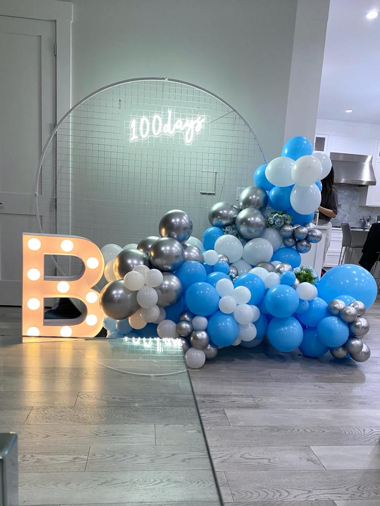 Blue and white balloon setup for a baby shower.