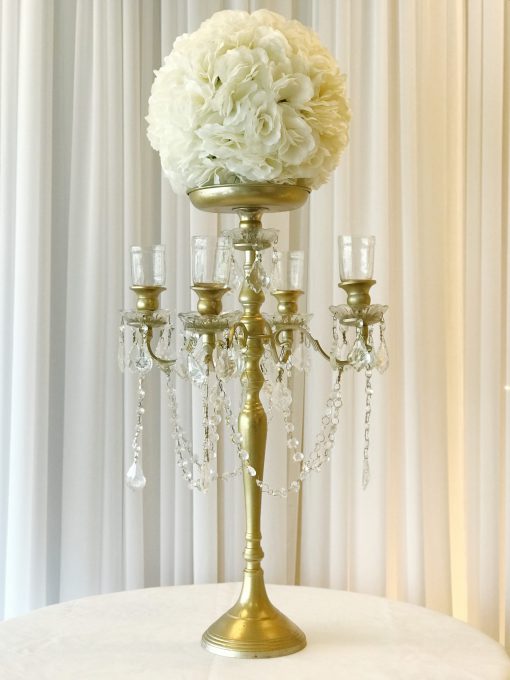 Silver candelabra with white silk ball centerpiece and candles.