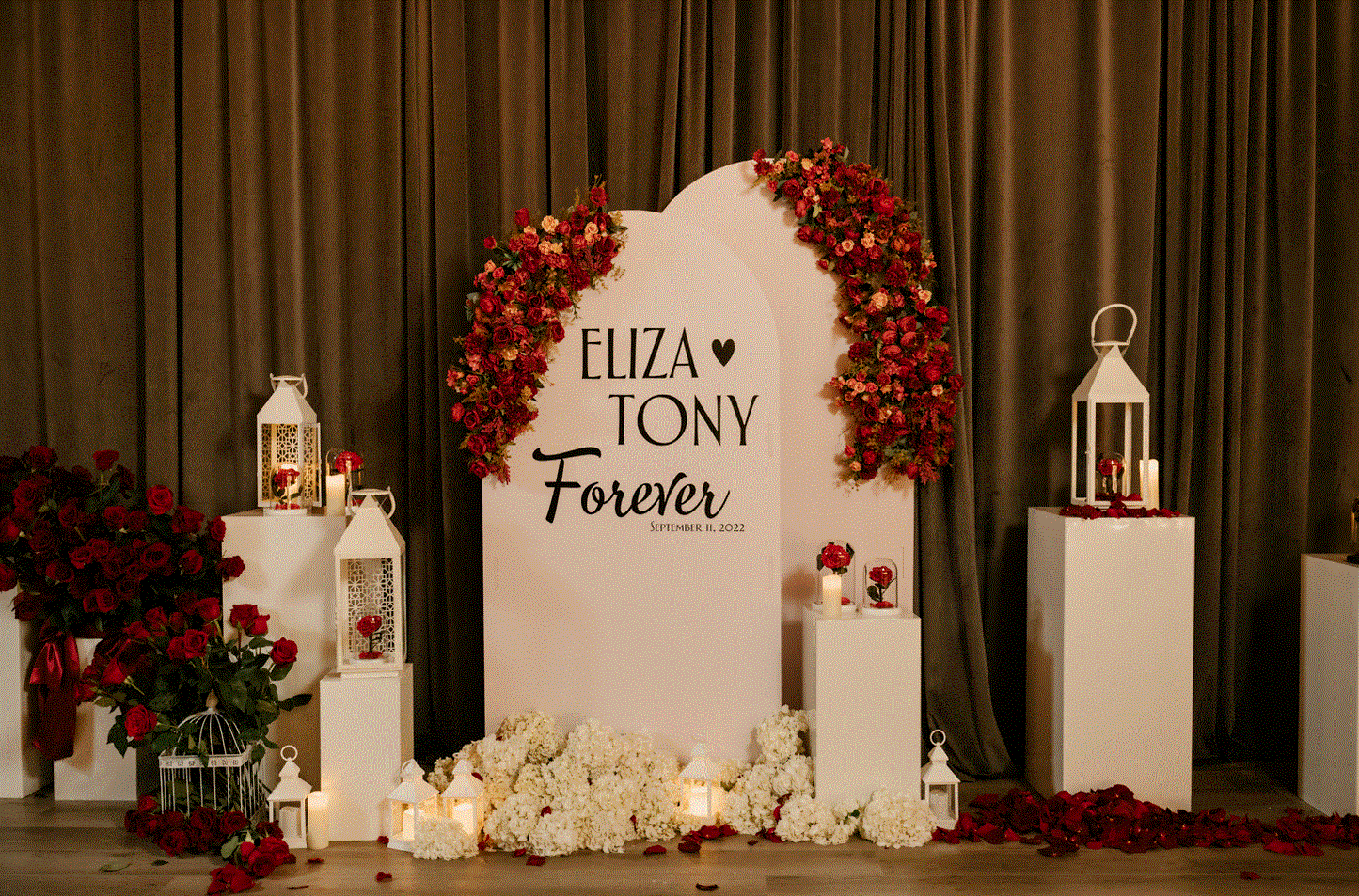 Decorated Round Top Backdrop with floral arrangements and a sign for a special occasion.