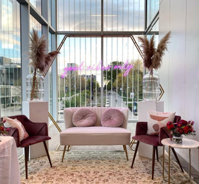 Luxurious gold metal hexagon arch setup indoors with beautiful decor.