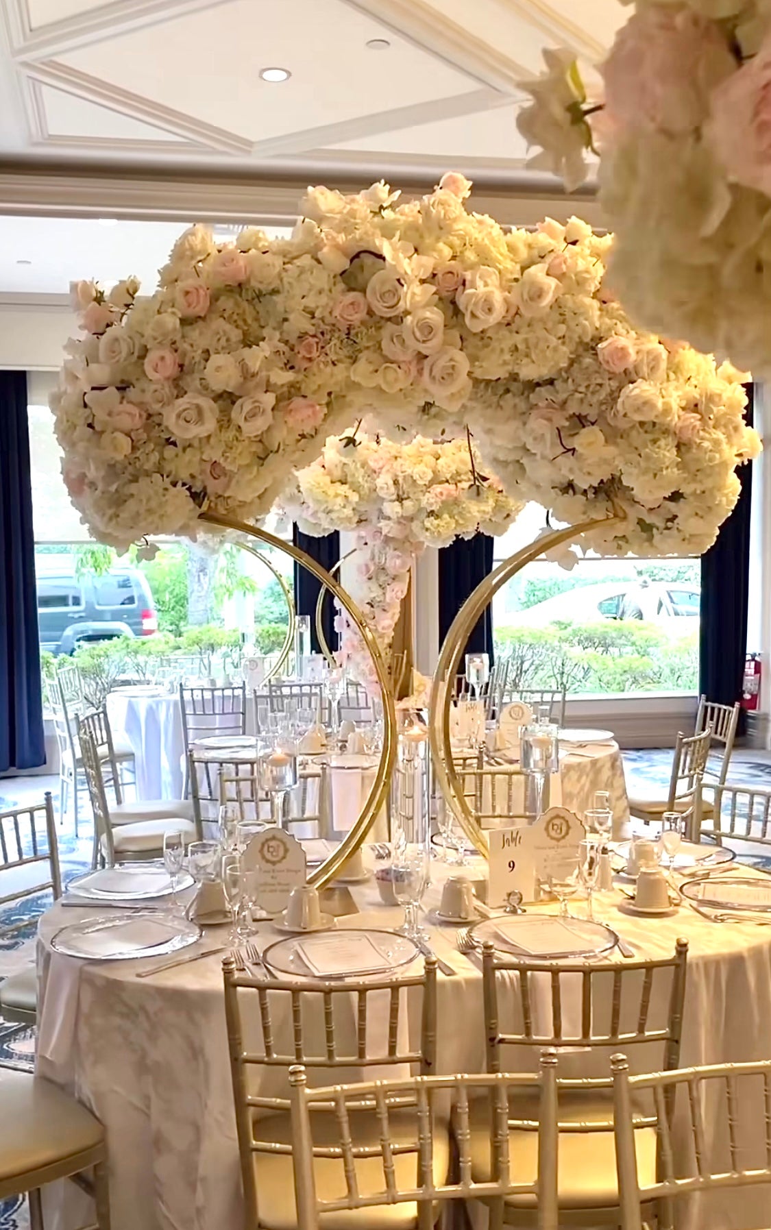 Luxurious silk flower centerpiece on a gold oval base, perfect for weddings and events.