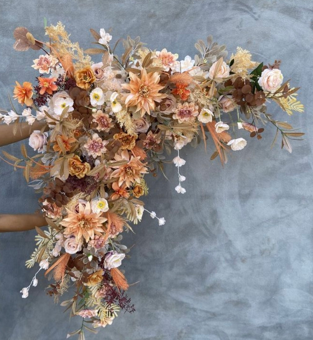 Peach and coral triangle arch piece with high-quality silk flowers for event decoration.