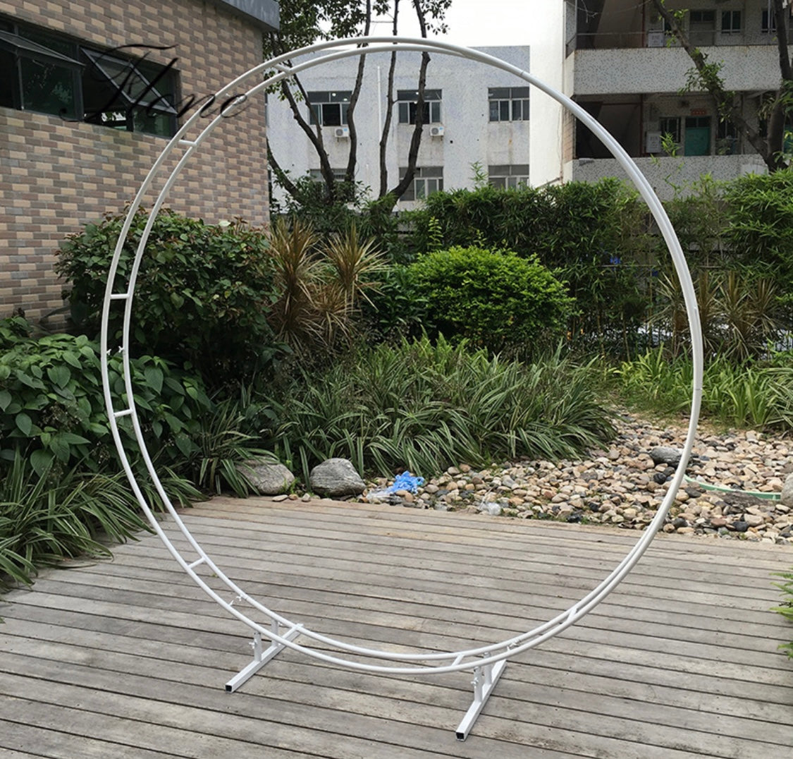 Bare Round Metal Arch set up on a patio, showcasing its sturdy metal frame.