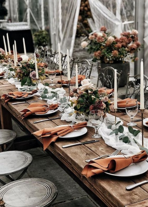 Romantic dinner setup with gold candle stick holders and white candles