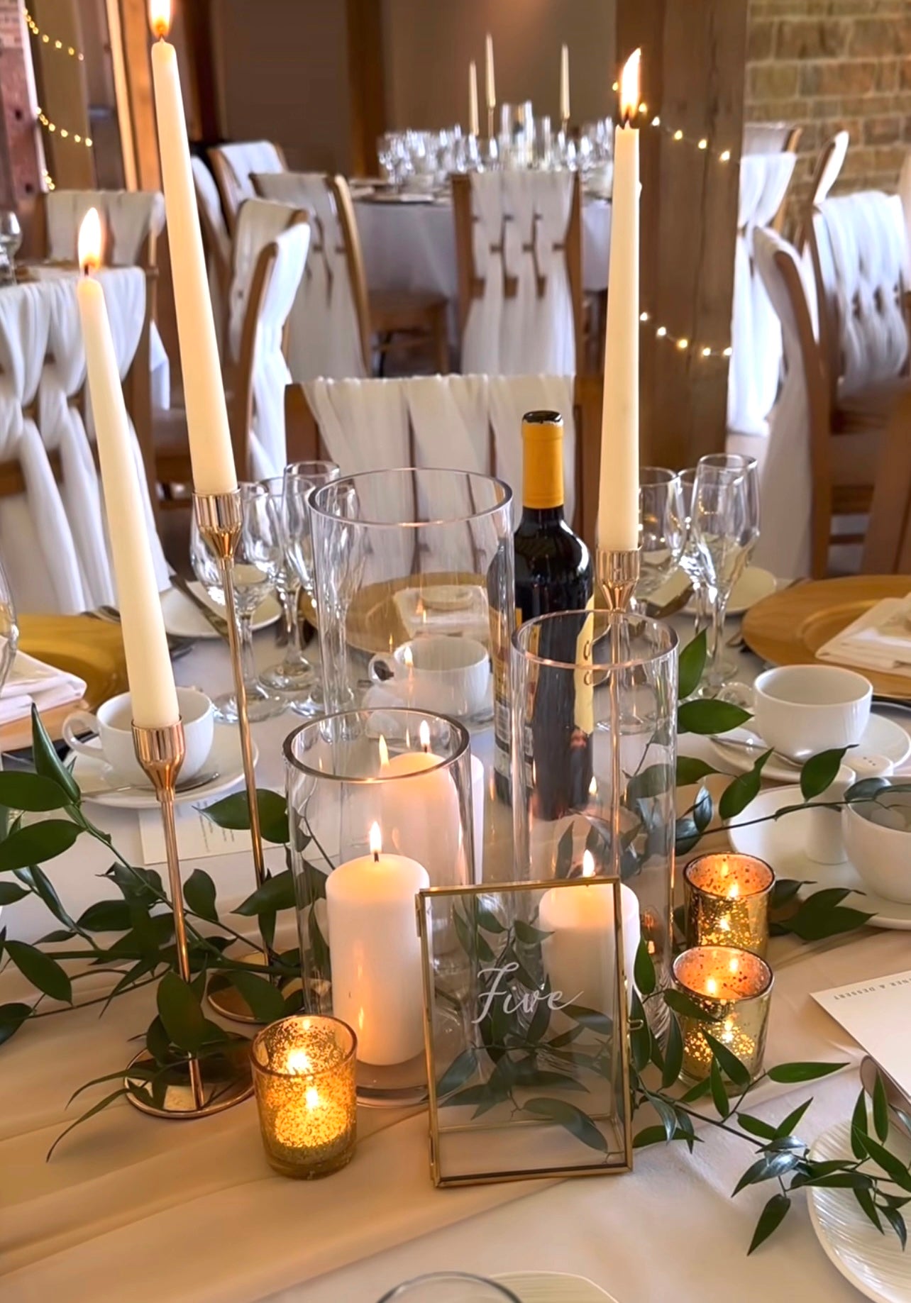 Romantic dinner setup with gold candle stick holders and white candles