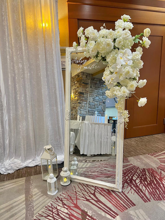 Selfie Mirror with Custom Vinyl Printing decorated with white flowers and lanterns in an elegant event setting.
