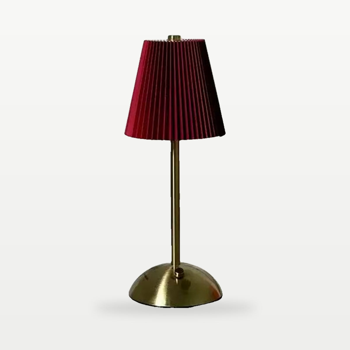 Cordless pleated table lamp with red shade and gold base