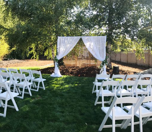 Elegant Arch Draping with Floral Decor at an Outdoor Wedding