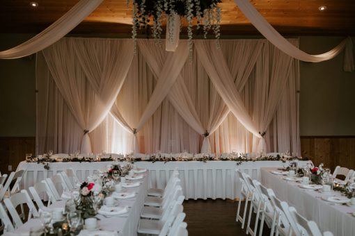 Backdrop with soft draping and lighting for a romantic event