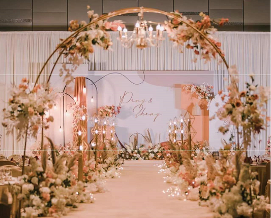 Elegant large semi circle double arch decorated with flowers for a wedding.