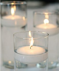 Floating candles in clear glass vases creating a serene ambiance.