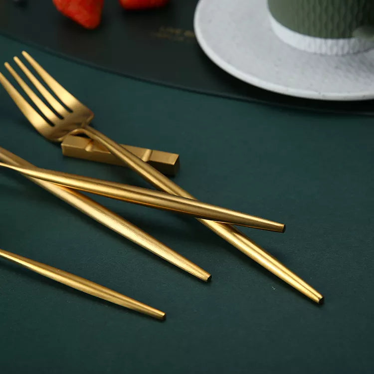 Close-up of gold cutlery set with sleek and modern design.