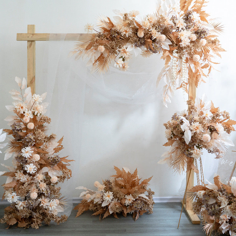Terracotta theme silk floral piece with a wooden frame backdrop.