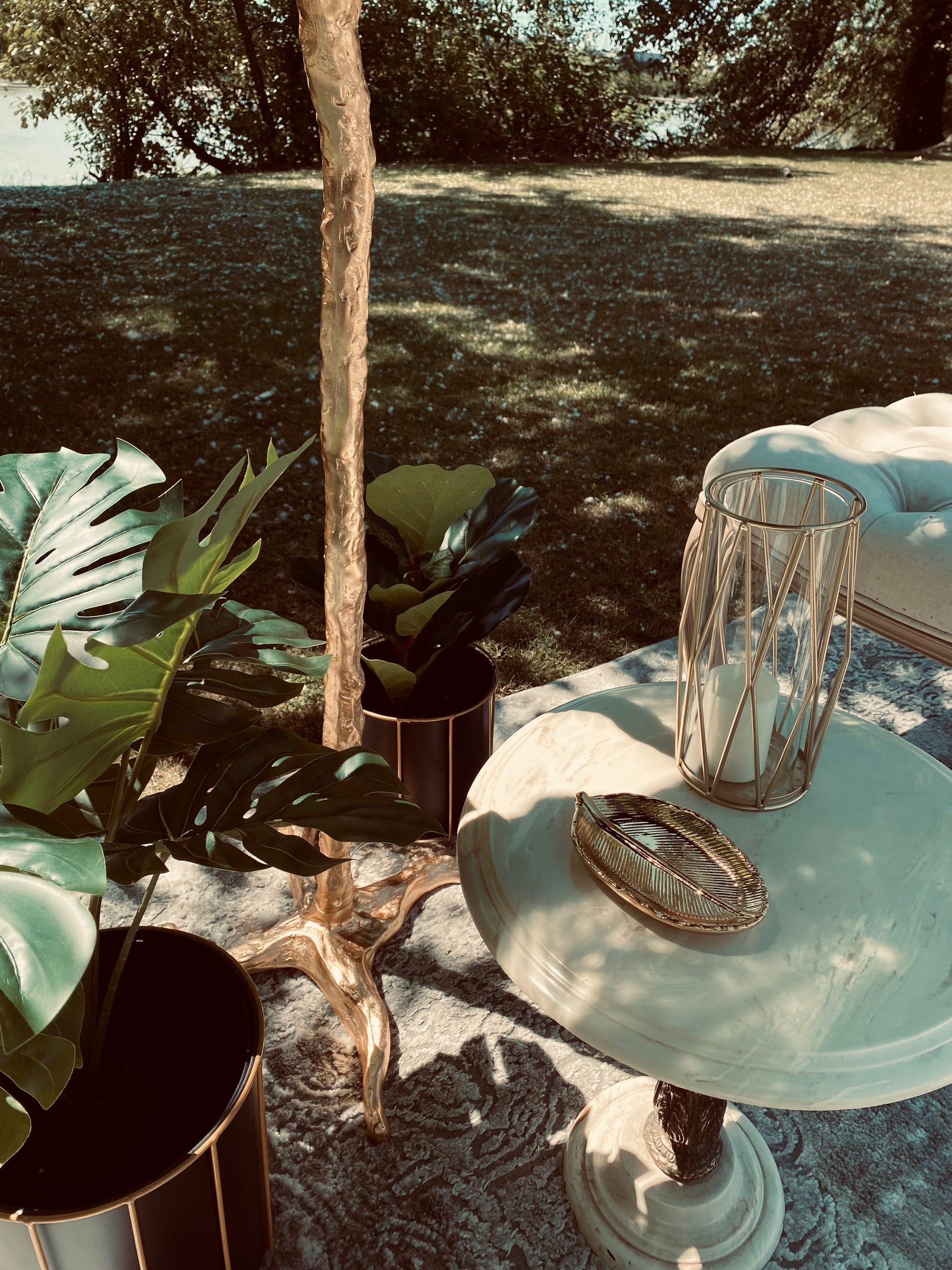 Close-up of the Antique Marble and Gold Side Table with decorative items.