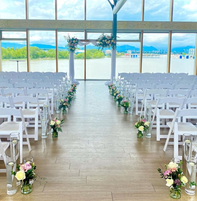 Floating candles in glass vases at a wedding.